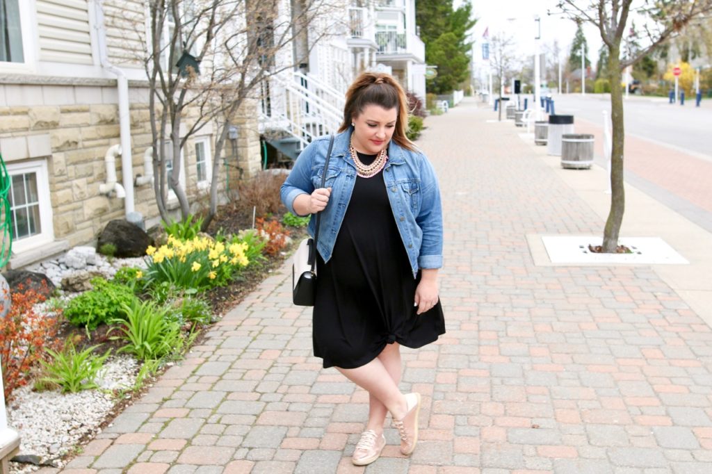 black dress with denim jacket and sneakers